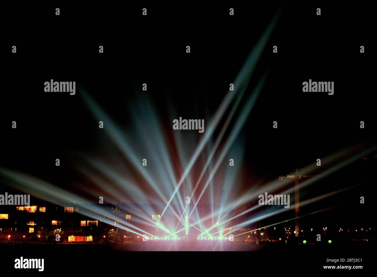 light beams in the night on the city promenade. Festive illumination