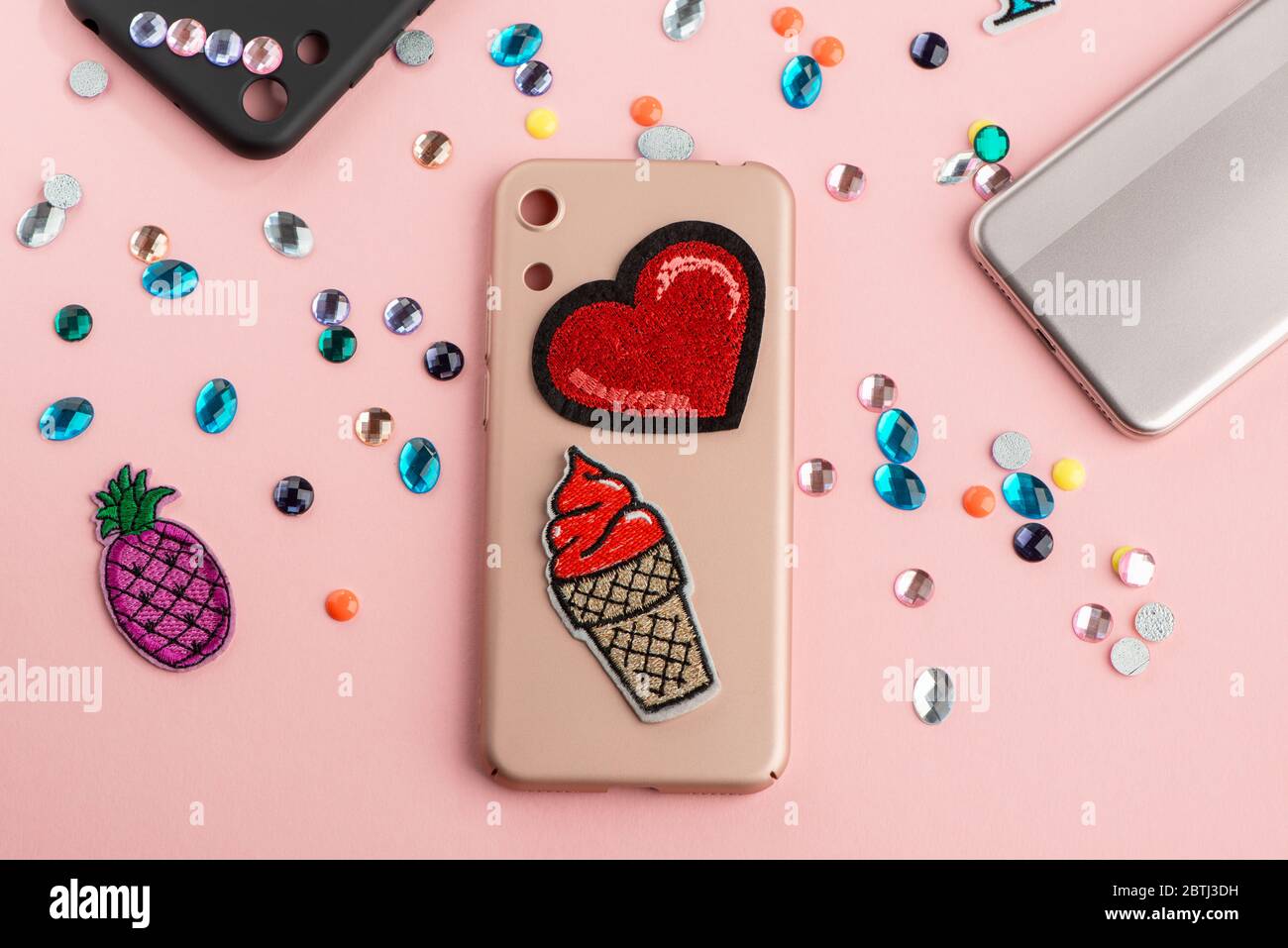 Red heart and ice cream patches on beige phone case Stock Photo