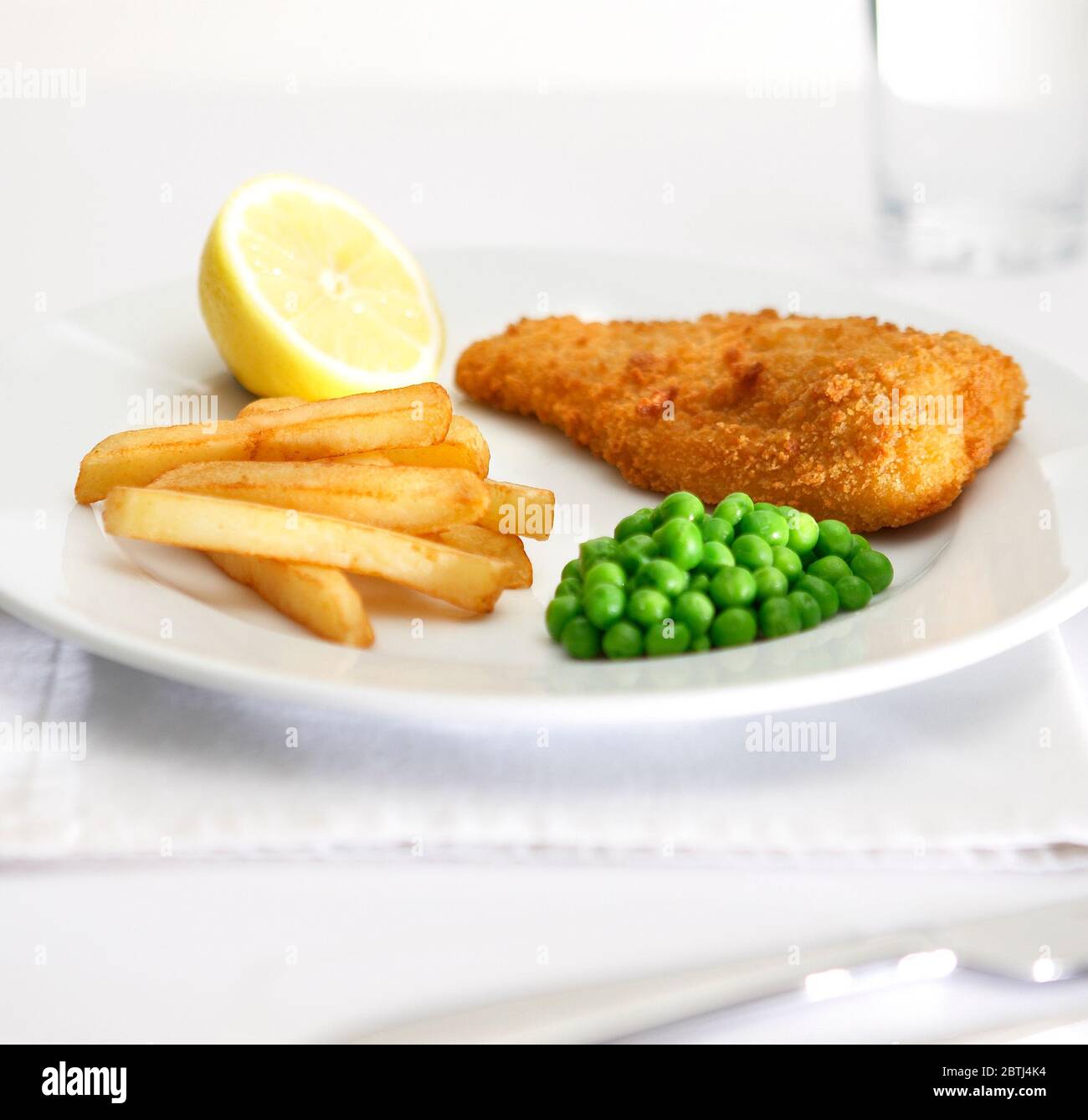 Bread crumbed fish and chips Stock Photo