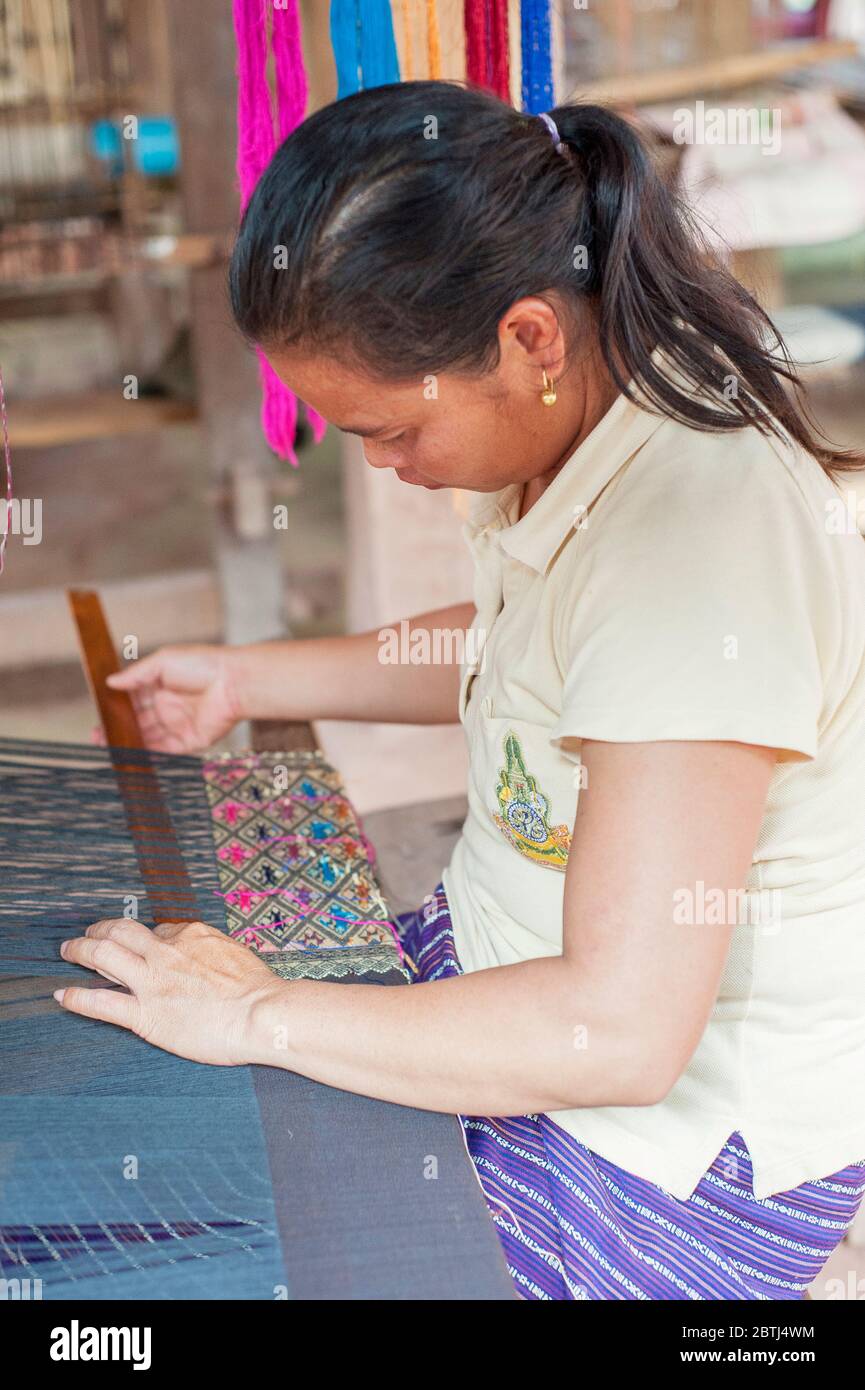 A Laotian Woman weaving using a Frame Loom, Northern Laos, Southeast Asia Stock Photo