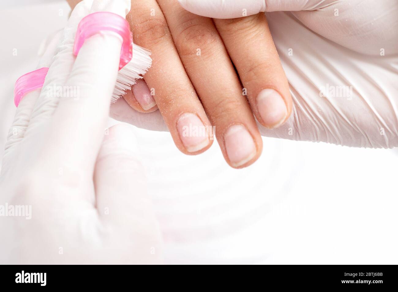 Close up of manicurist hands removing dust from nails by brush cleaning  nails in manicure salon Stock Photo - Alamy