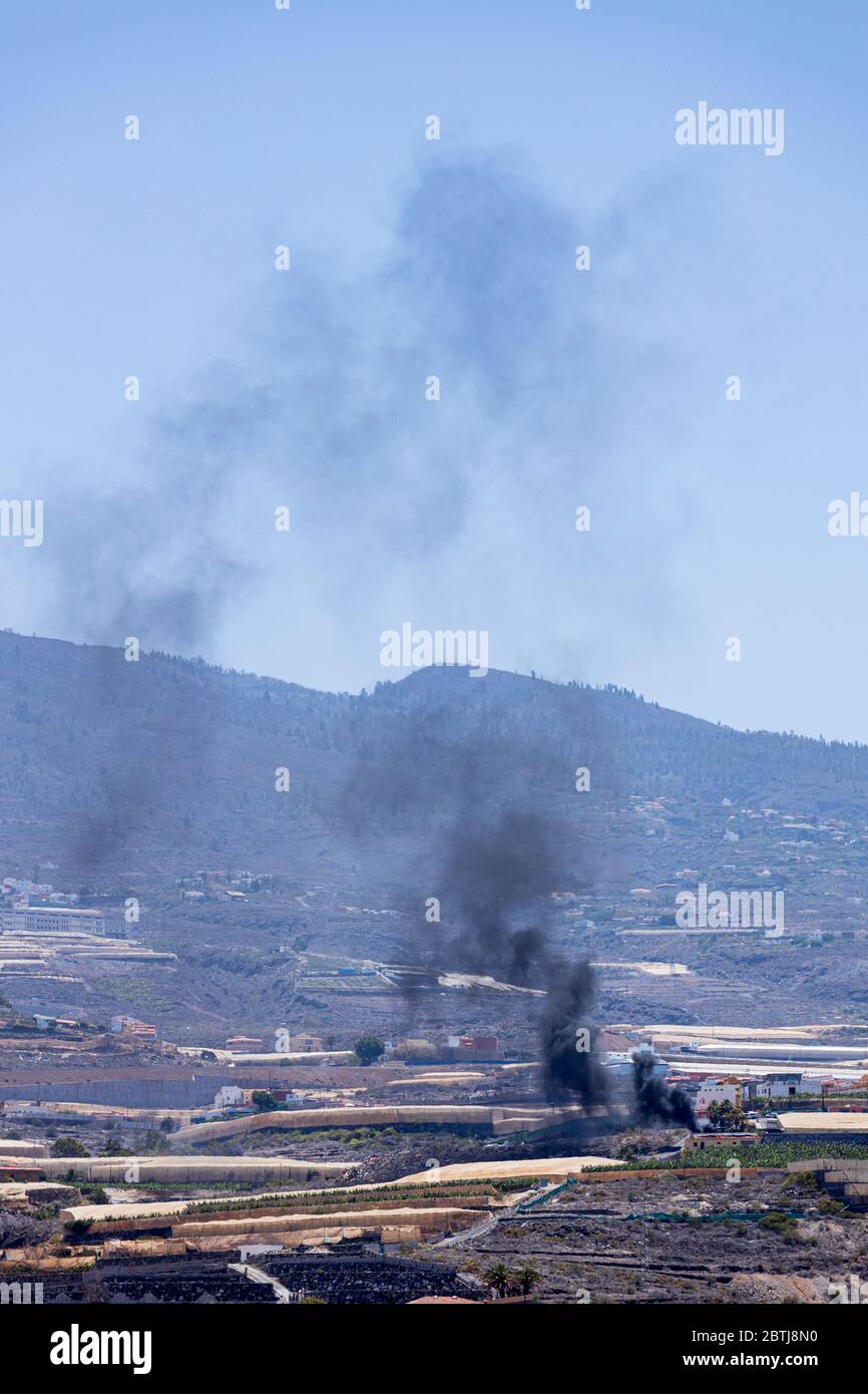 Black smoke from rubbish burning polluting the air in the hillside during phase two of the de-escalation of the state of emergency, covid 19, coronavi Stock Photo