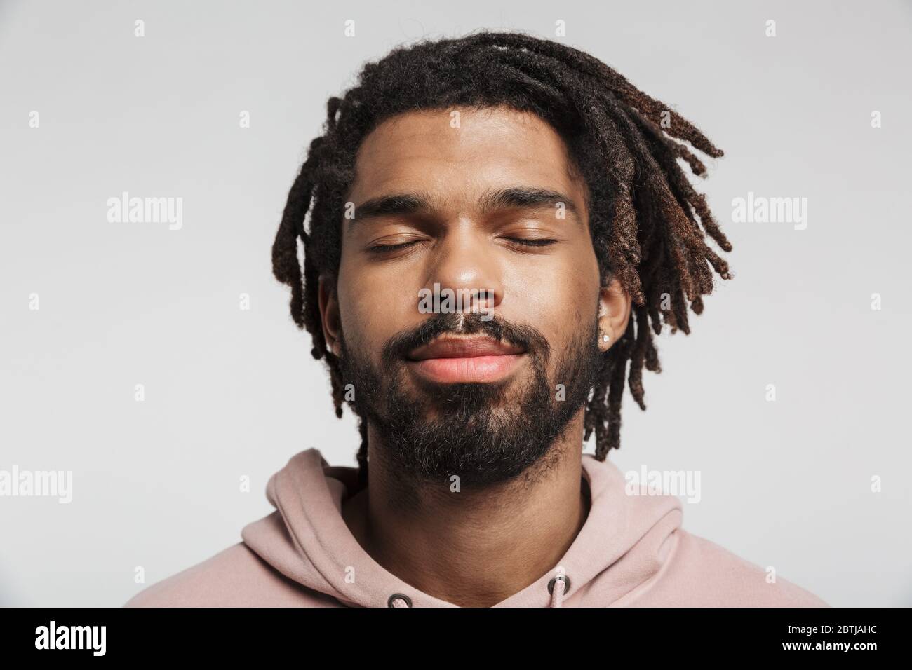 Close up portrait of a young african man wearing hoodie standing ...