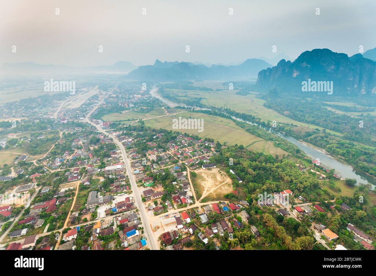 Aerial view from a Hot Air Balloon over Vang Vieng town, the Nam Song River and the  limestone mountains. Vang Vieng, Laos, Southeast Asia Stock Photo