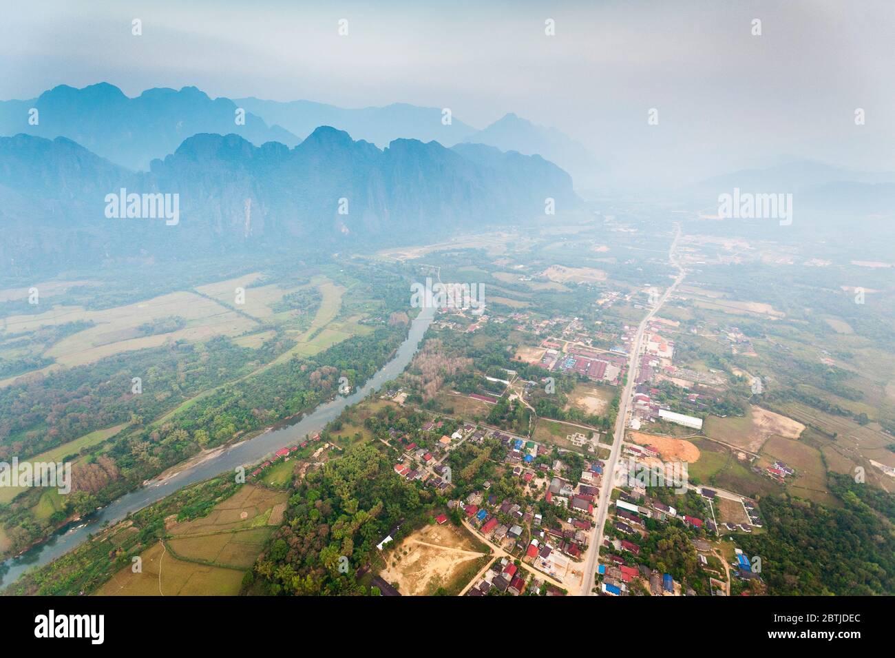 Aerial view from a Hot Air Balloon over Vang Vieng town, the Nam Song River and the  limestone mountains. Vang Vieng, Laos, Southeast Asia Stock Photo