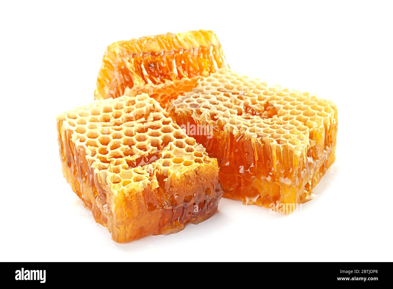 Yellow Honeycomb slice closeup isolated on white background Stock Photo