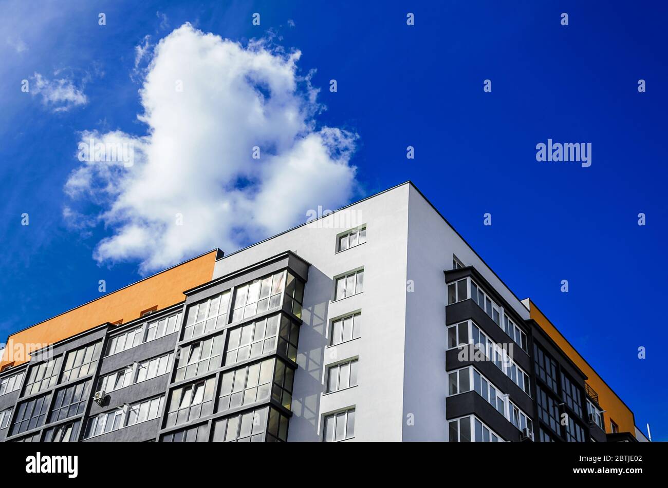 Apartment building on background of blue sky with clouds Stock Photo ...