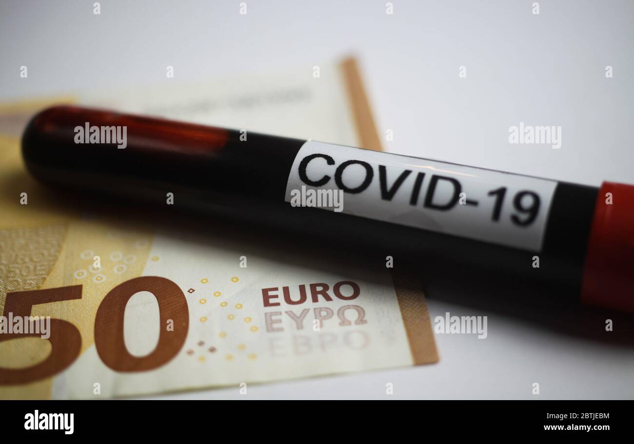 Financial immediate emergency action concept: Close up of isolated 50 Euro paper money bank note with blood sample tube and text covid-19 (focus on wo Stock Photo