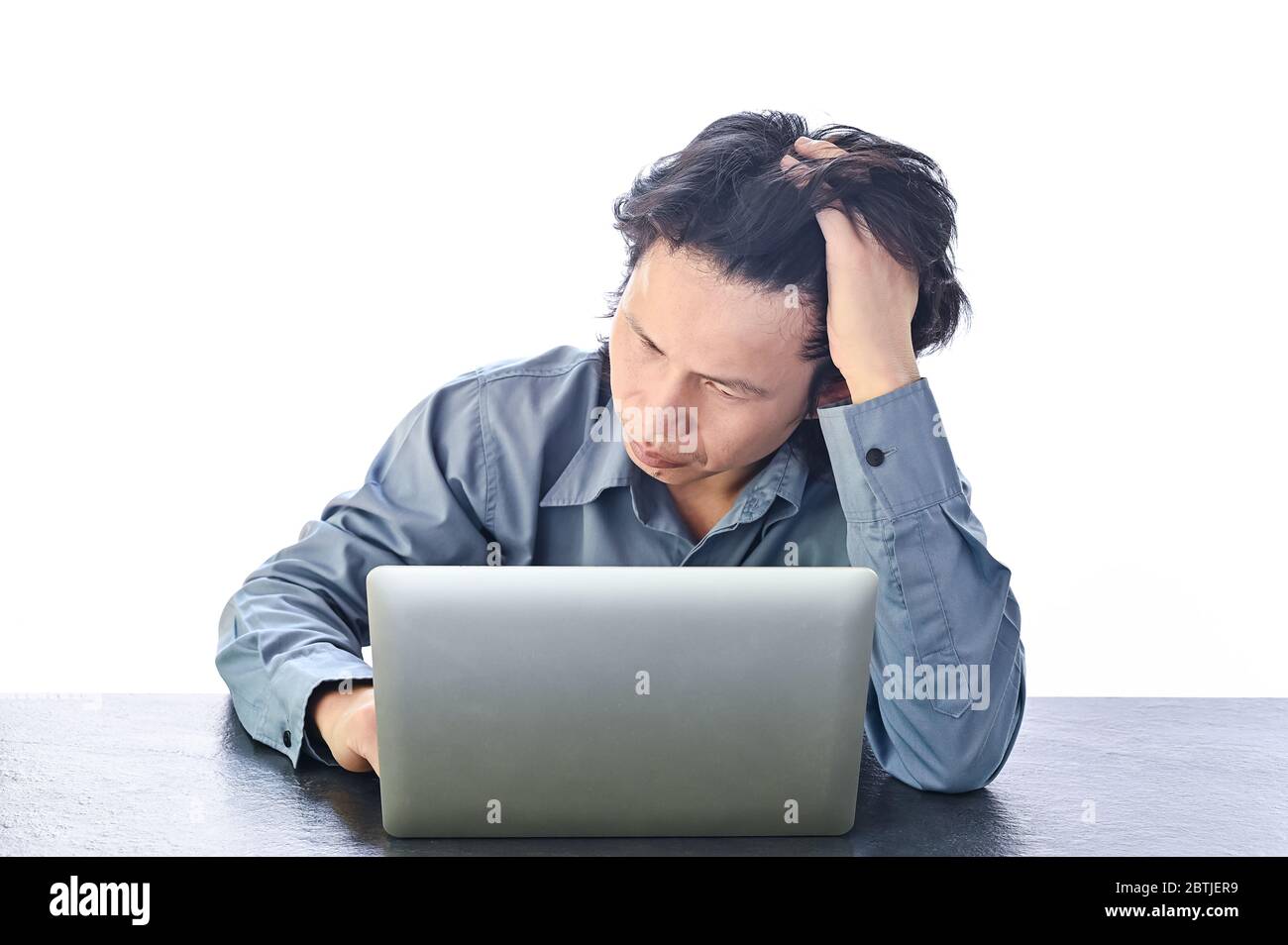 Asian Business man stress or tension in office with burnout syndrome at desk work related Stress and Burnout Stock Photo