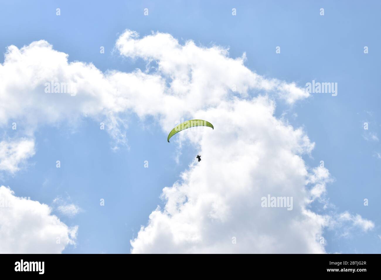 Yellow parachute in the blue sky Stock Photo