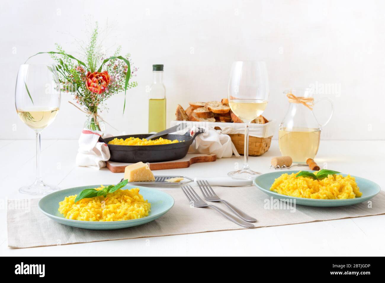 Risotto Milanese, wooden table with traditional Italian saffron risotto