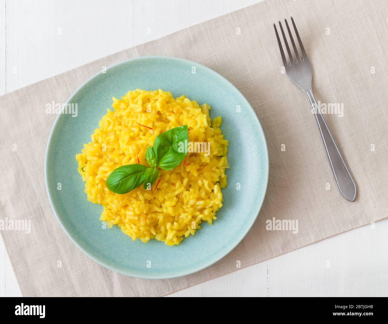 Risotto Milanese, the dish with traditional Italian saffron risotto. Top down view. Stock Photo