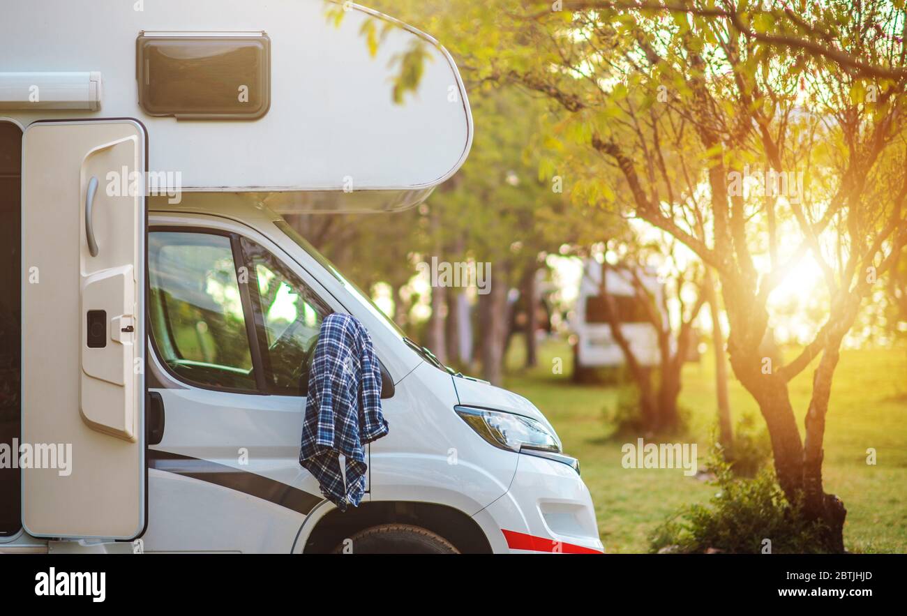 Recreational Vehicle Summer Road Trip Theme. Sunset Point RV Park and the Camper Van. Summer Time Fun on Campsite. Stock Photo