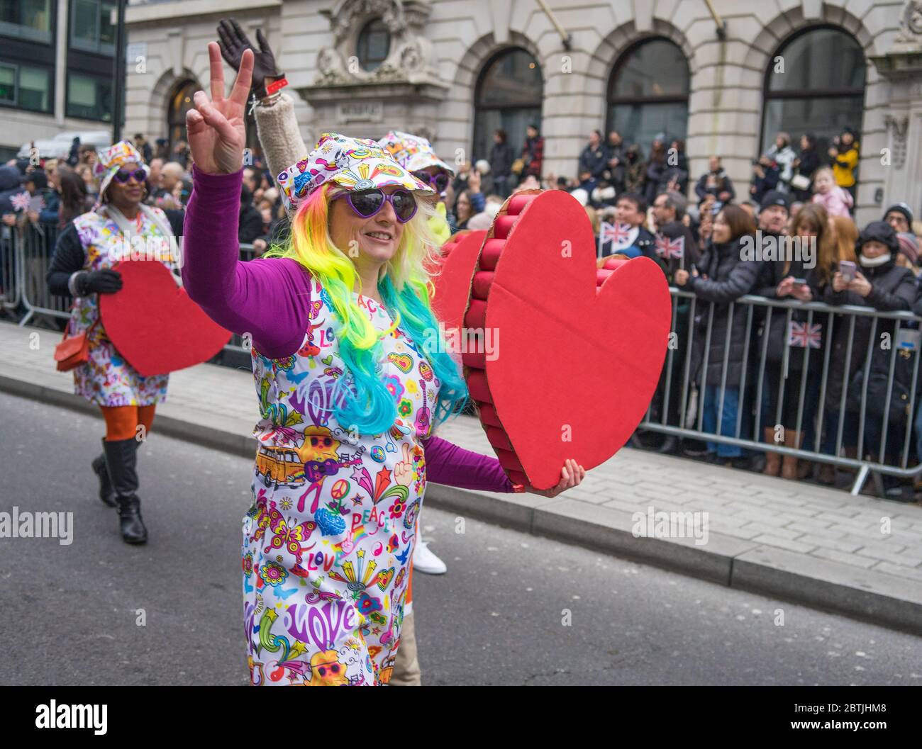 London New Years Day Parade 2020. Lady with rainbow hair holding a big red heart. Stock Photo
