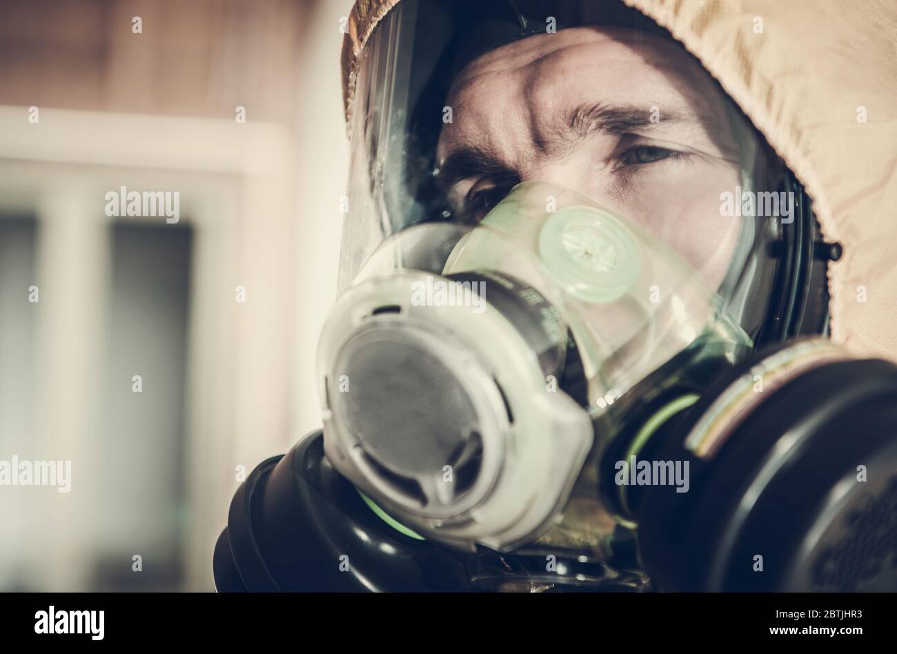 Very Tired Men in Safety Biohazard Mask Covering His Face. Disinfection Public Places During Virus Pandemic. Stock Photo
