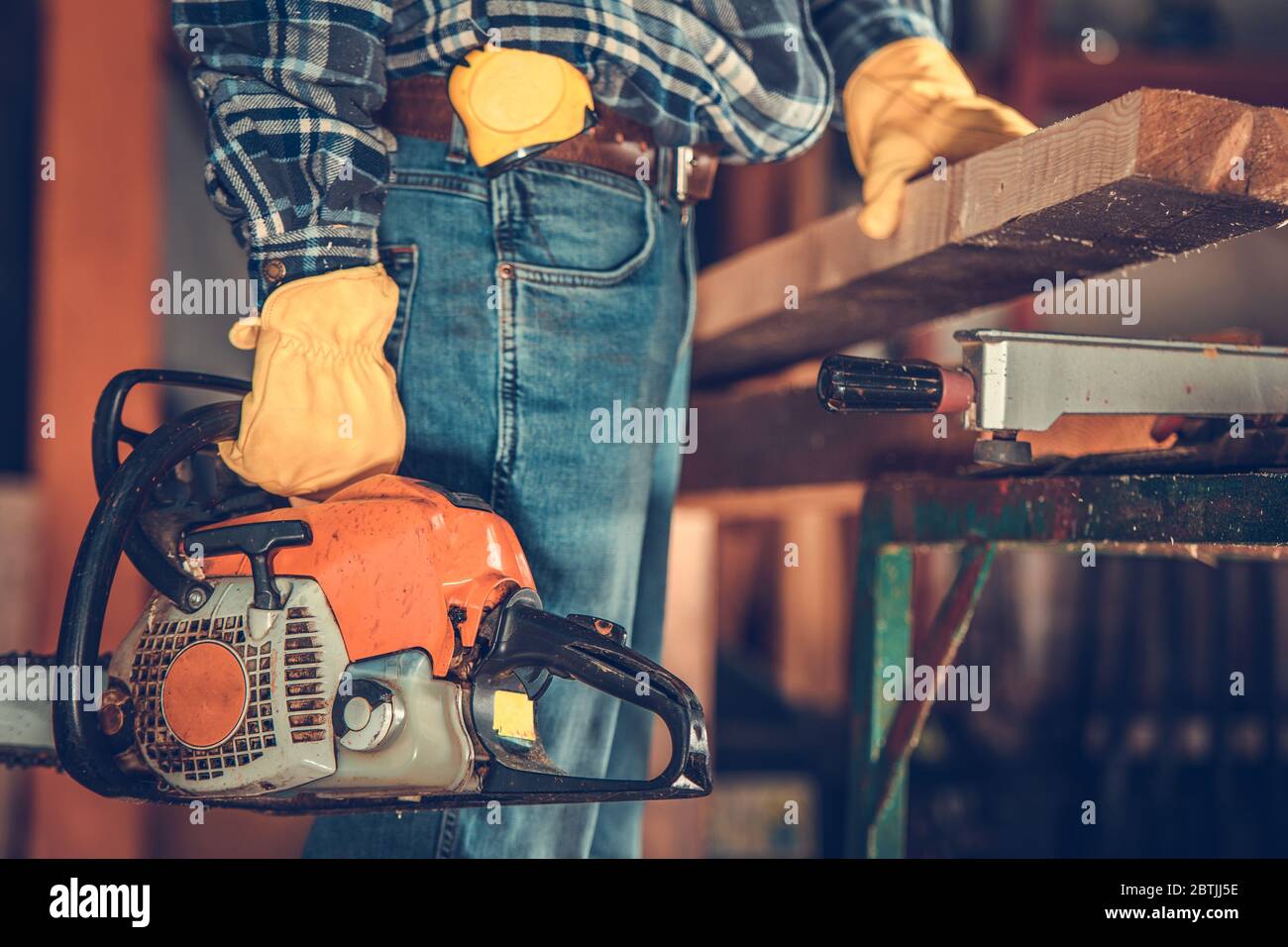 Men with Gasoline Saw Woodwork Project. Building Using Wood Material. Construction Industry. Stock Photo