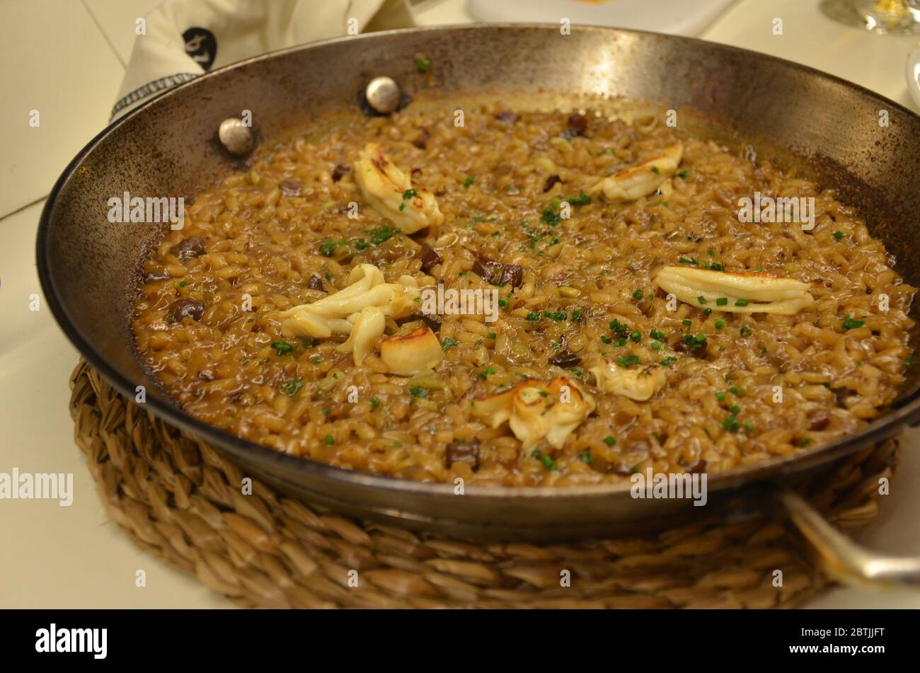 Paella is a Spanish rice dish originally from Valencia. Paella is one of the best-known dishes in Spanish cuisine. Stock Photo