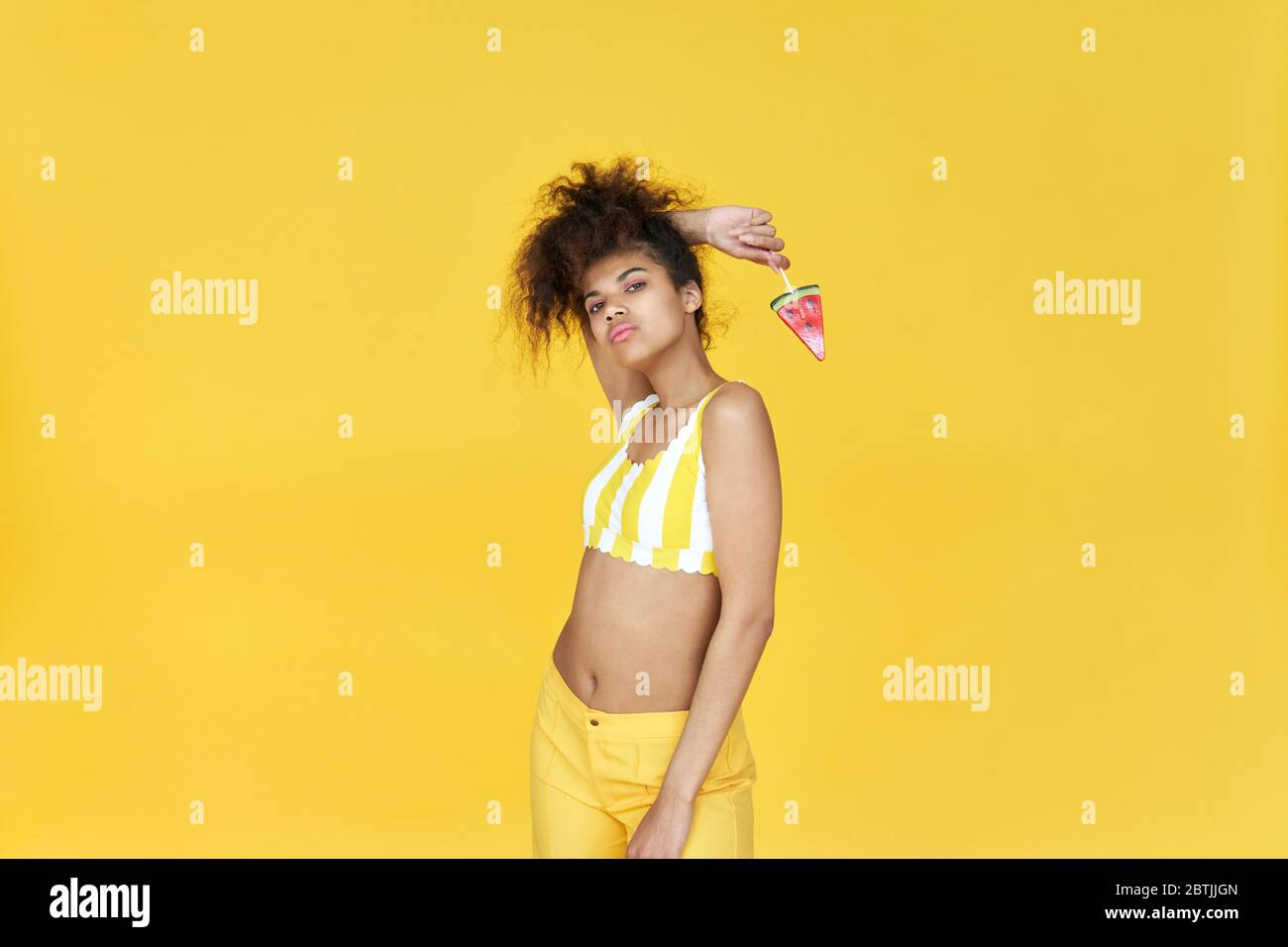 Cool african gen z teen girl hold candy isolated on yellow summer  background Stock Photo - Alamy