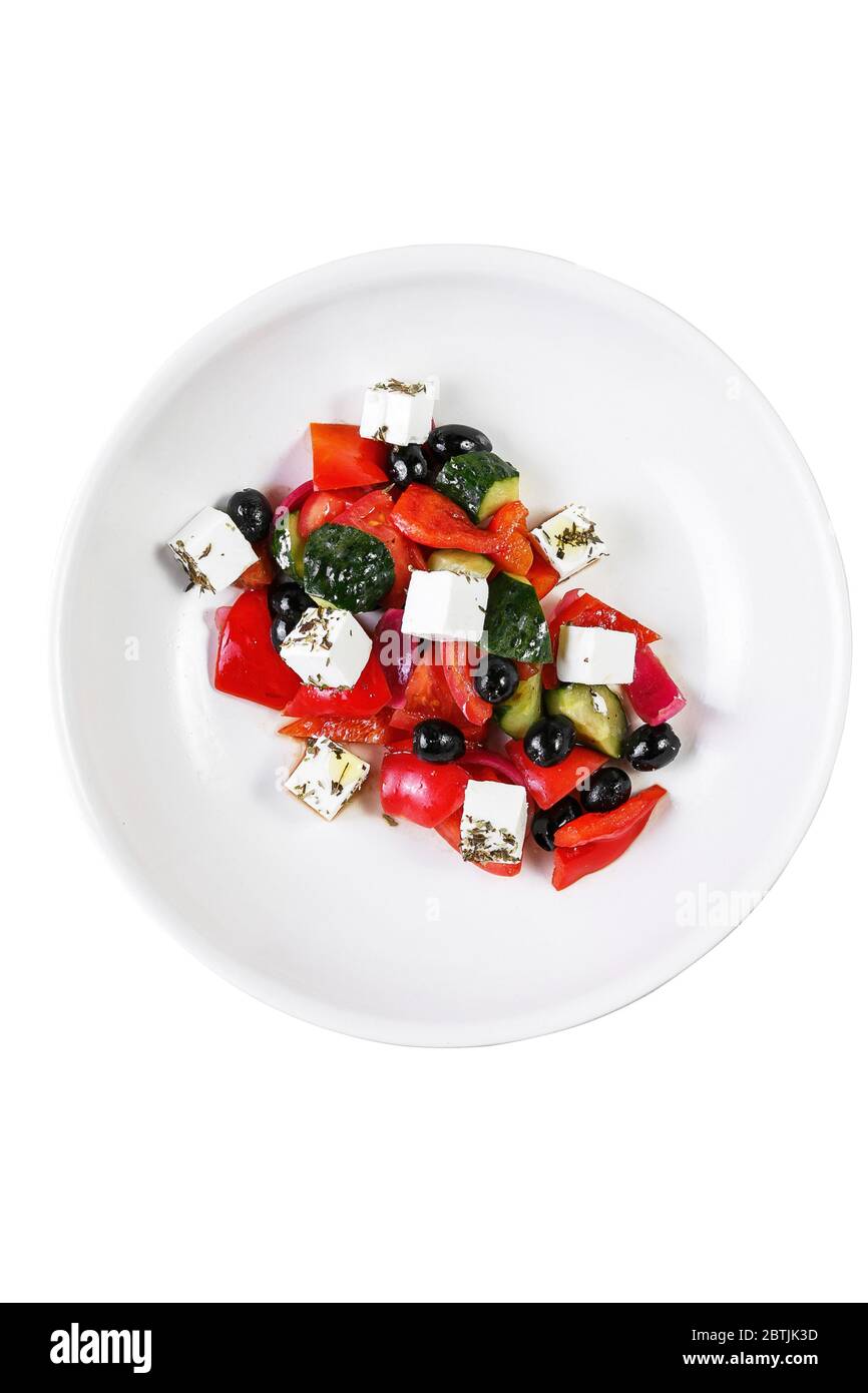 Top view of large freshly made traditional greek salad in white ceramic bowl, isolated on white Stock Photo