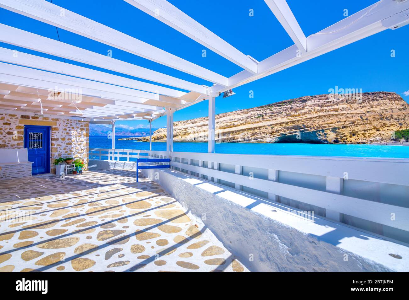 Matala beach with caves on the rocks that were used as a roman cemetery and at the decade of 70's were living hippies from all over the world, Crete, Stock Photo