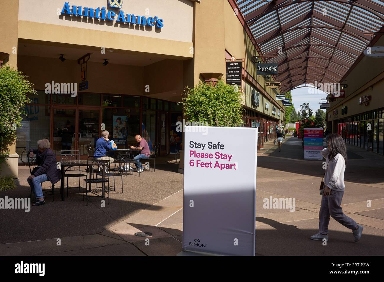 Signs encouraging social distancing are seen in the Woodburn Premium