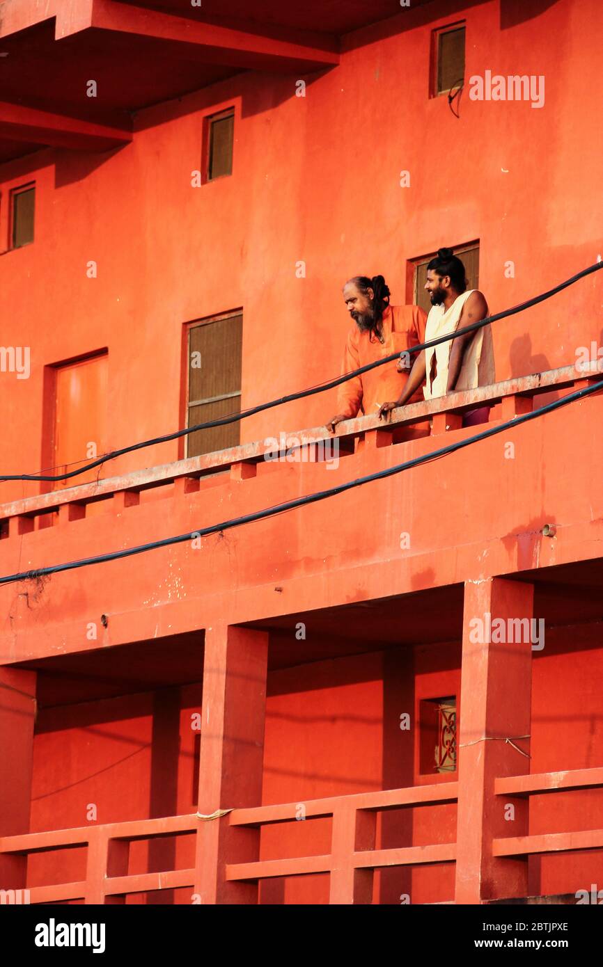 India, Varanasi - Uttar Pradesh state, 31st July 2013. In the morning, from the top of a balcony, two men watch the Ganges river. Stock Photo