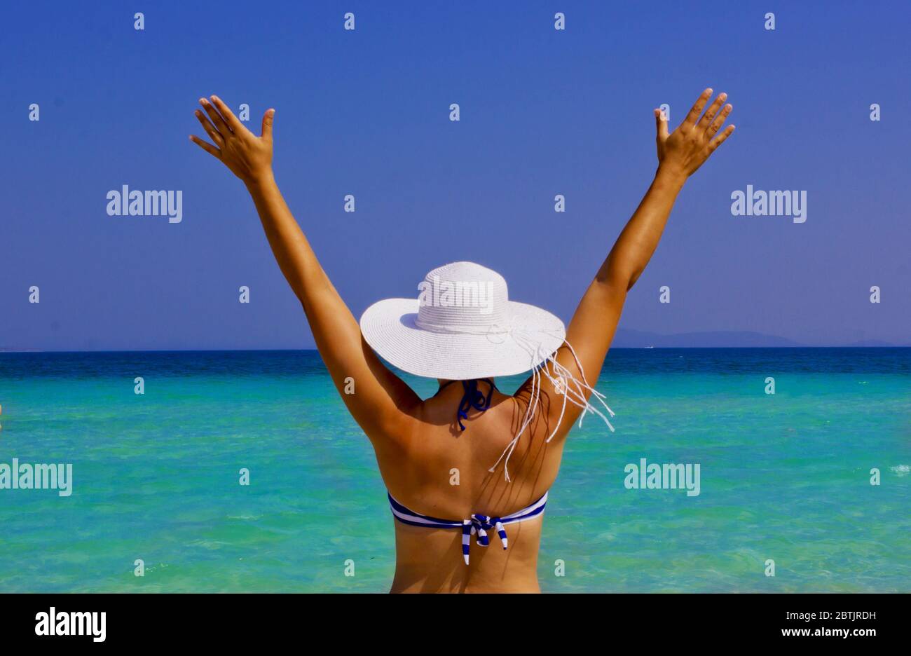 beautiful young woman in a hat on the beach Stock Photo