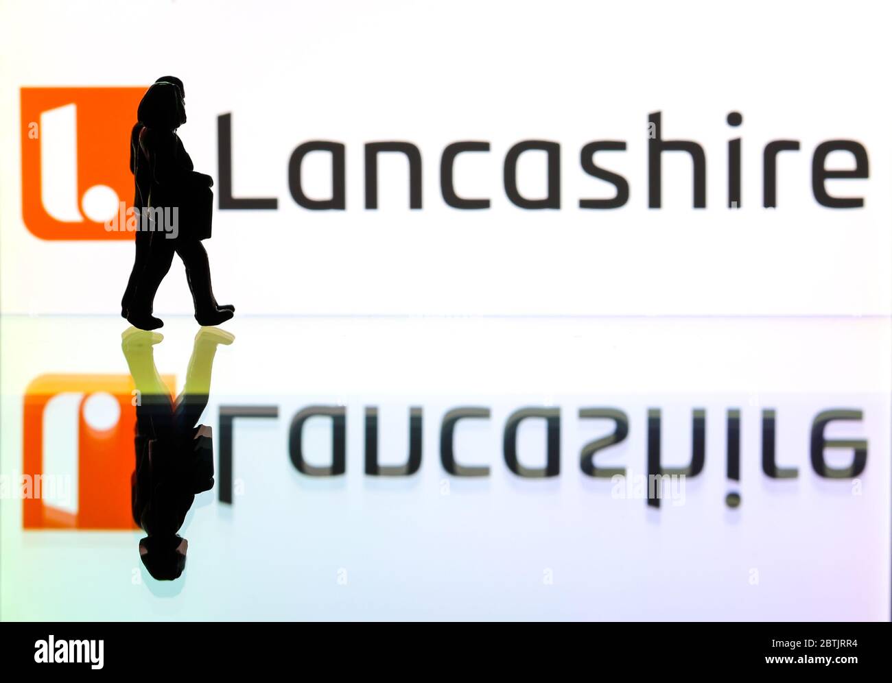 silhouettes in front of the logo Lancashire Group (editorial use only
