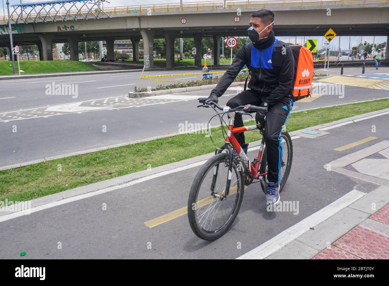 A domiciliary on a bicycle in the north of Bogotá. In preventive isolation that seeks to stop the spread of the corona virus, covid-19 Stock Photo