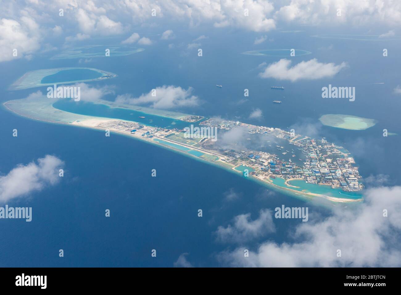 Maldives island capital island, Male. Hulhumale city island view from over the clouds. Aerial landscape in exotic travel destination Stock Photo