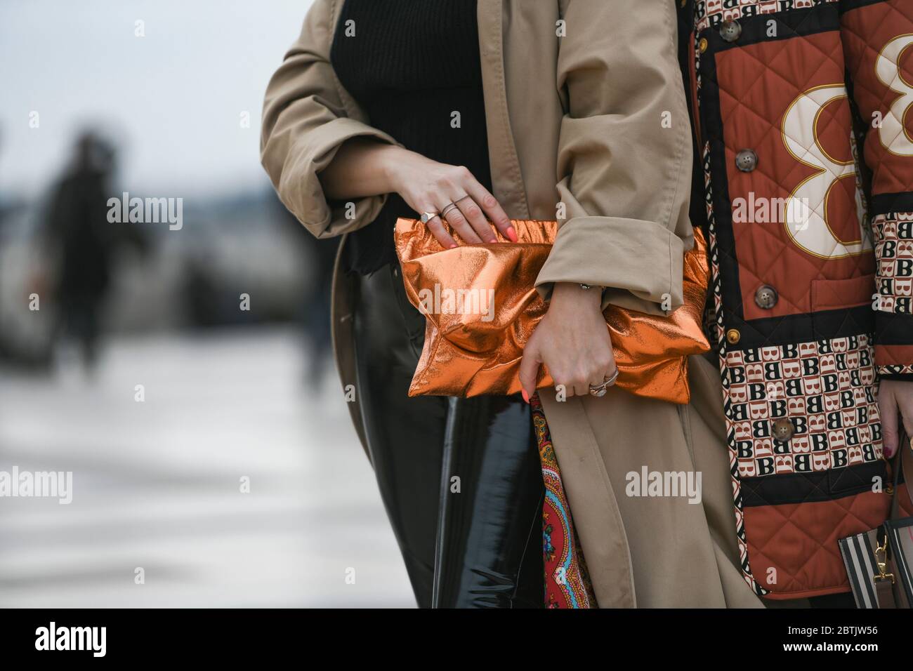 Paris, France - February 29, 2020: Neon orange clutch bag detail - streetstylefw20 Stock Photo