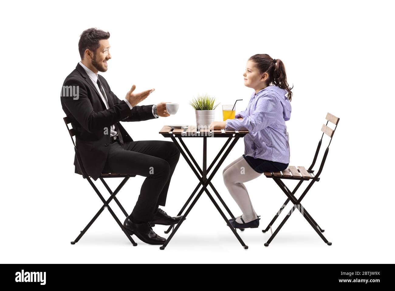 Father and daughter sitting at a cafe and talking isolated on white ...