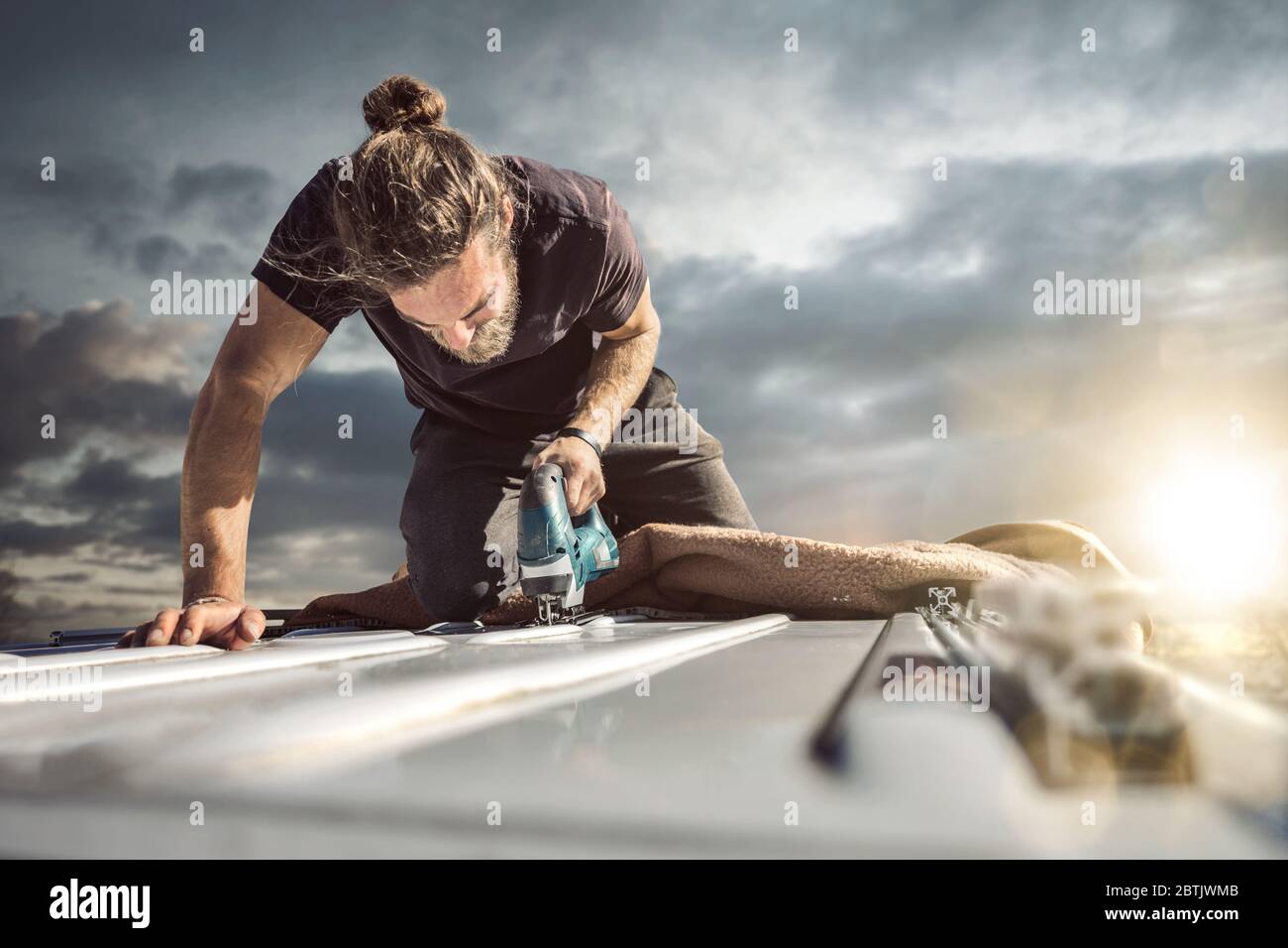 Young man working with a jigsaw Stock Photo