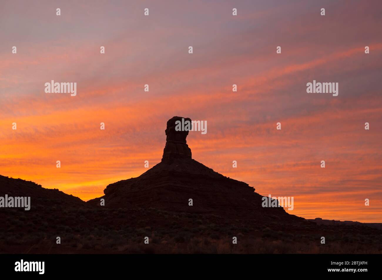 UT00677-00...UTAH - Towering butte at sunset in the Valley of the Gods, an area of critical environmental concern. Stock Photo