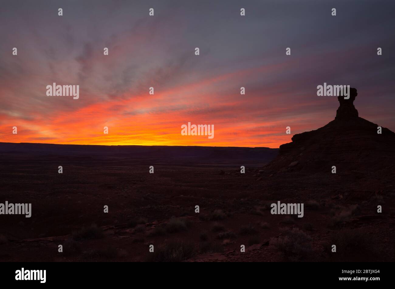 UT00677-00...UTAH - Towering butte at sunset in the Valley of the Gods, an area of critical environmental concern. Stock Photo