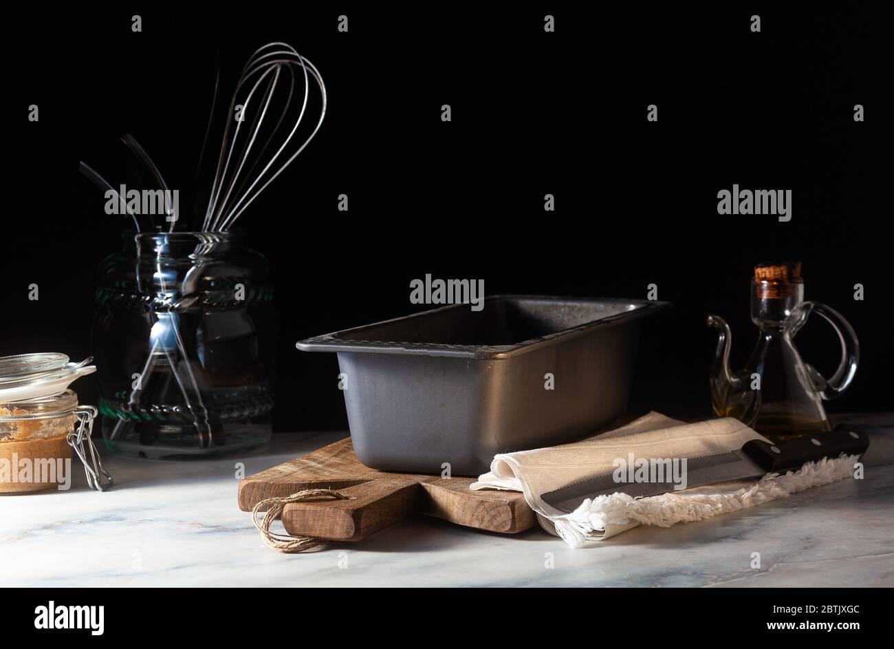 a baking tray for baking bread on the kitchen table, dark background Stock Photo