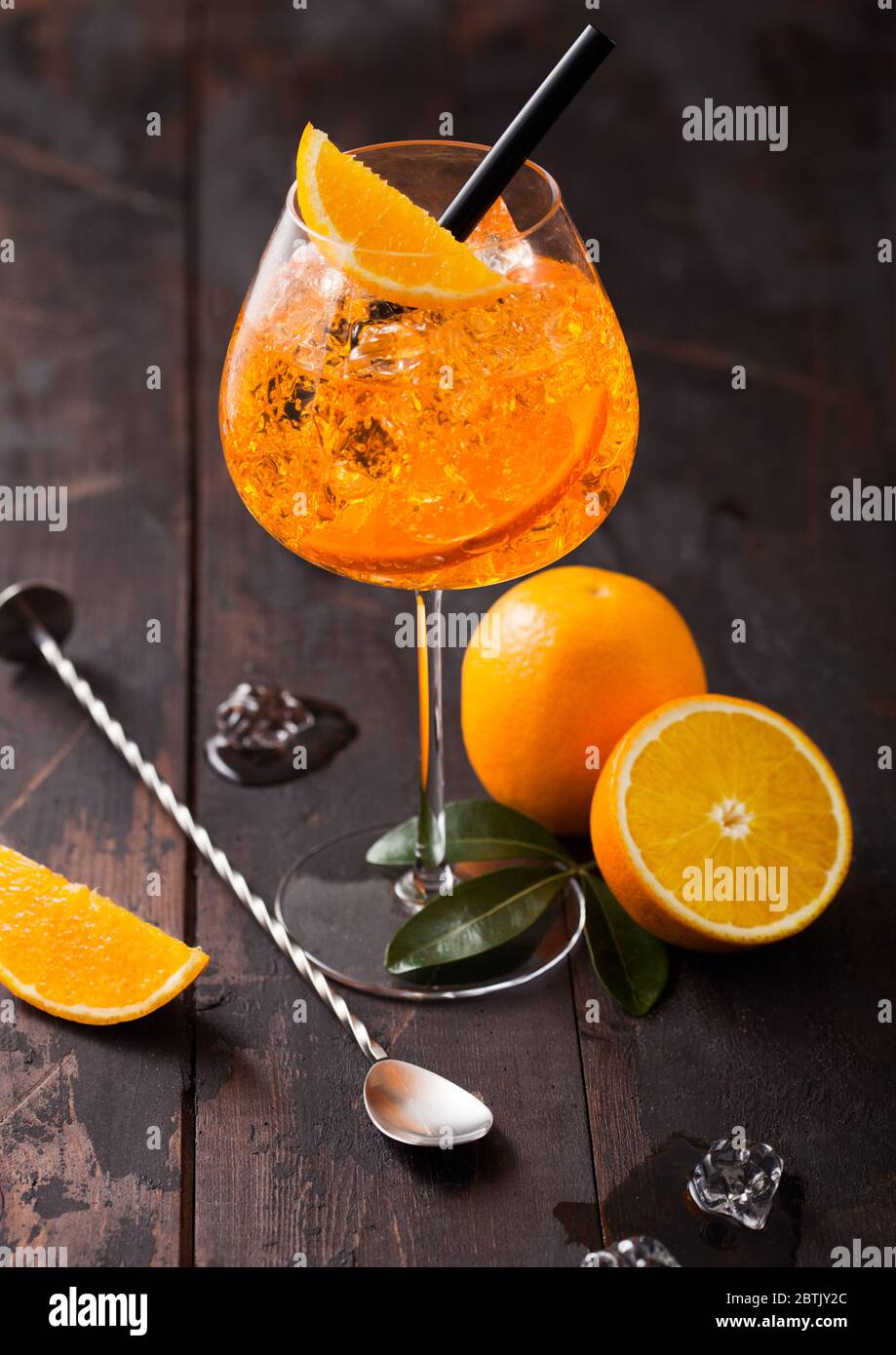 Glass of aperol spritz summer cocktail with orange slices and bar spoon ...