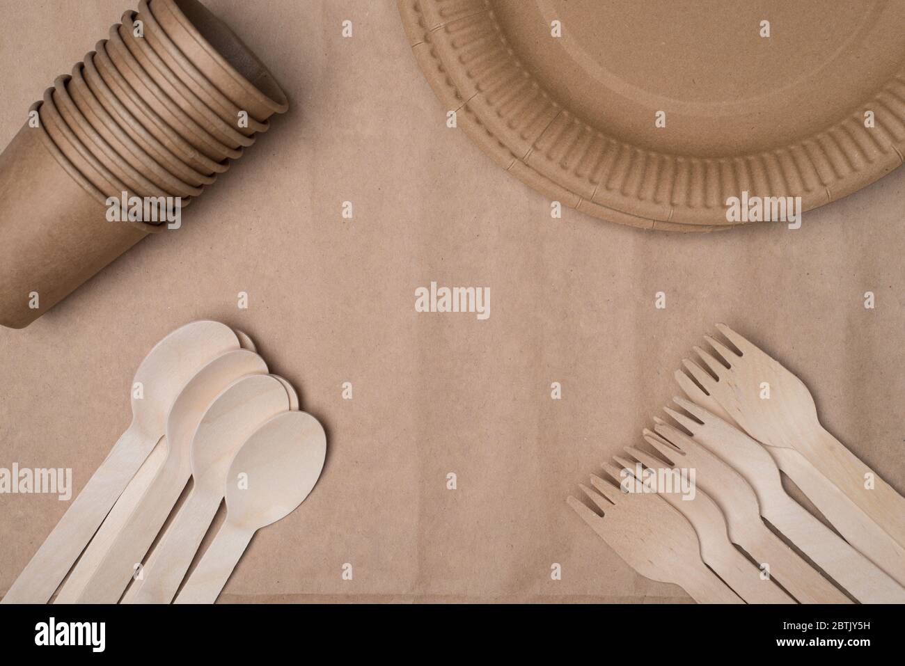Top above overhead view photo of wooden cutlery, paper cups and plates ...