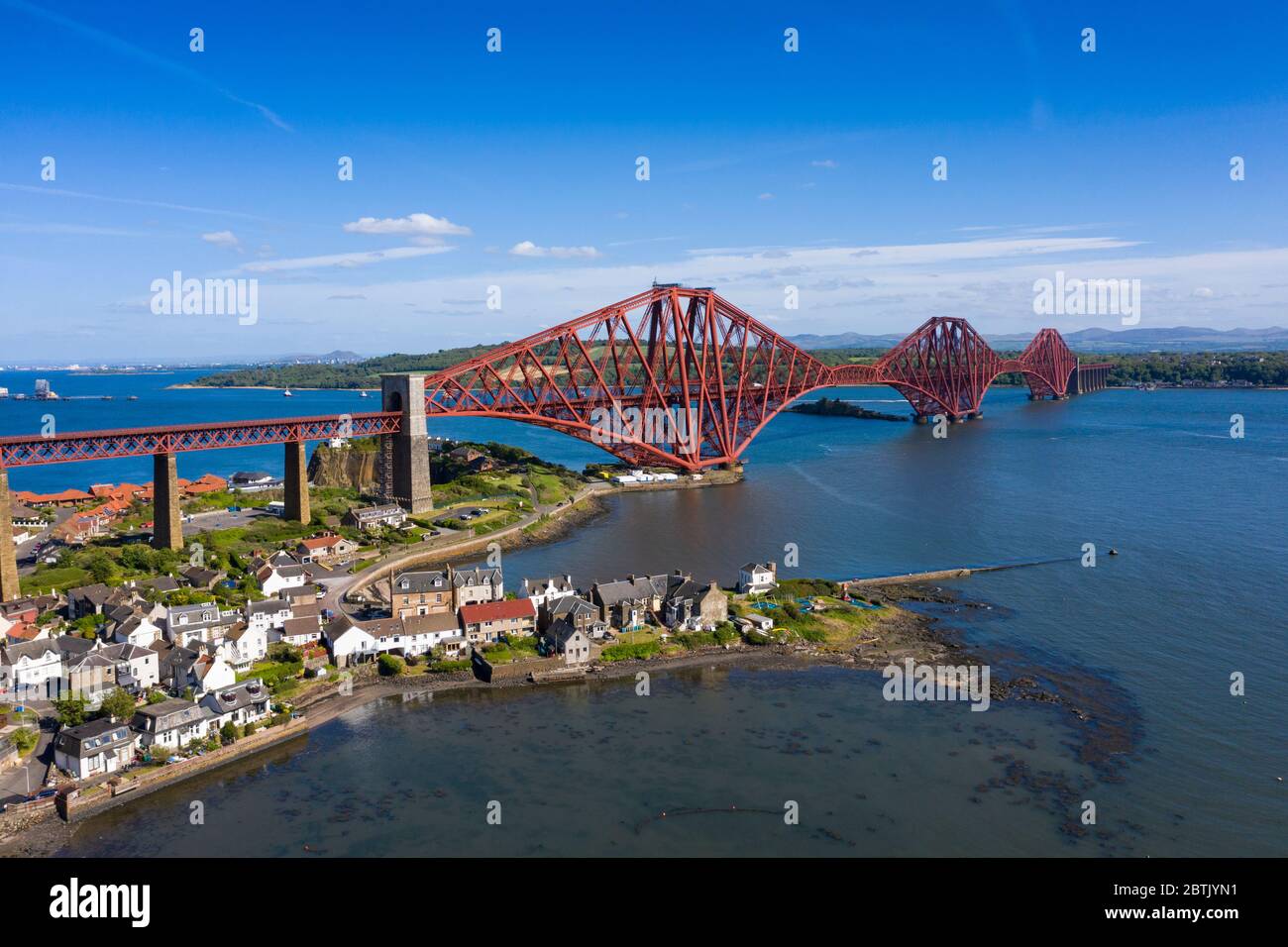 Aerial view of Forth Bridge crossing the River Forth and village of North Queensferry, Fife, Scotland, UK