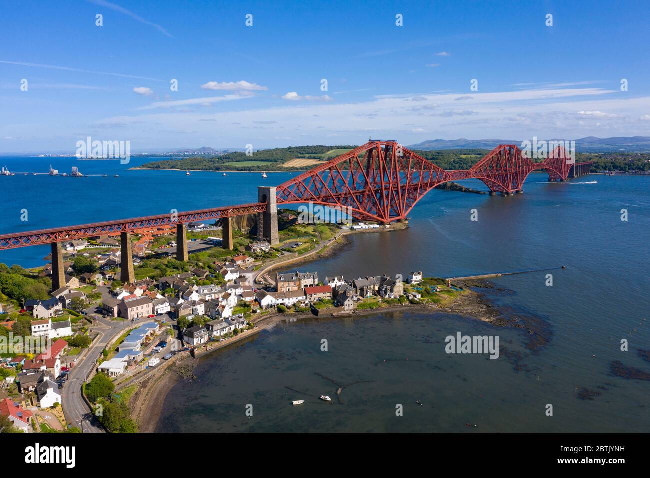 Aerial view of Forth Bridge crossing the River Forth and village of North Queensferry, Fife, Scotland, UK Stock Photo