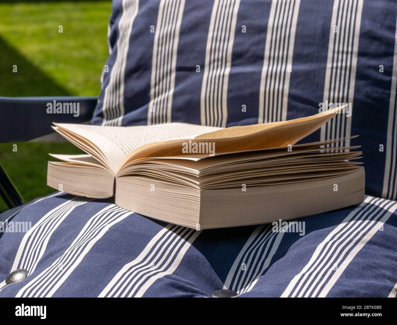 Paperback book on a sun lounger Stock Photo