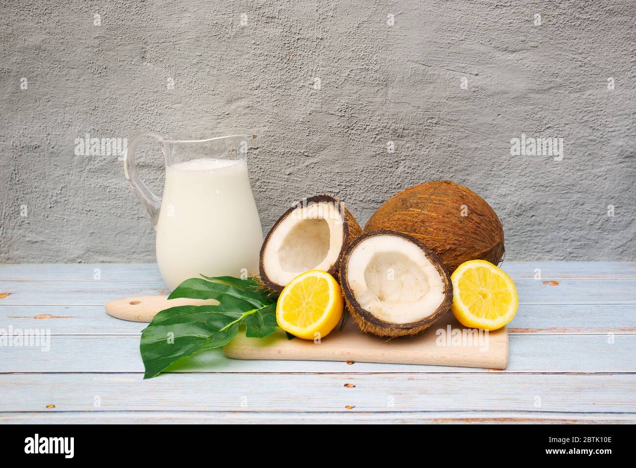 Coconuts and lemons on the table with coconut milk Stock Photo