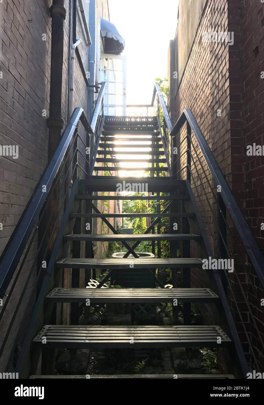 Straight stair between two exterior walls Stock Photo