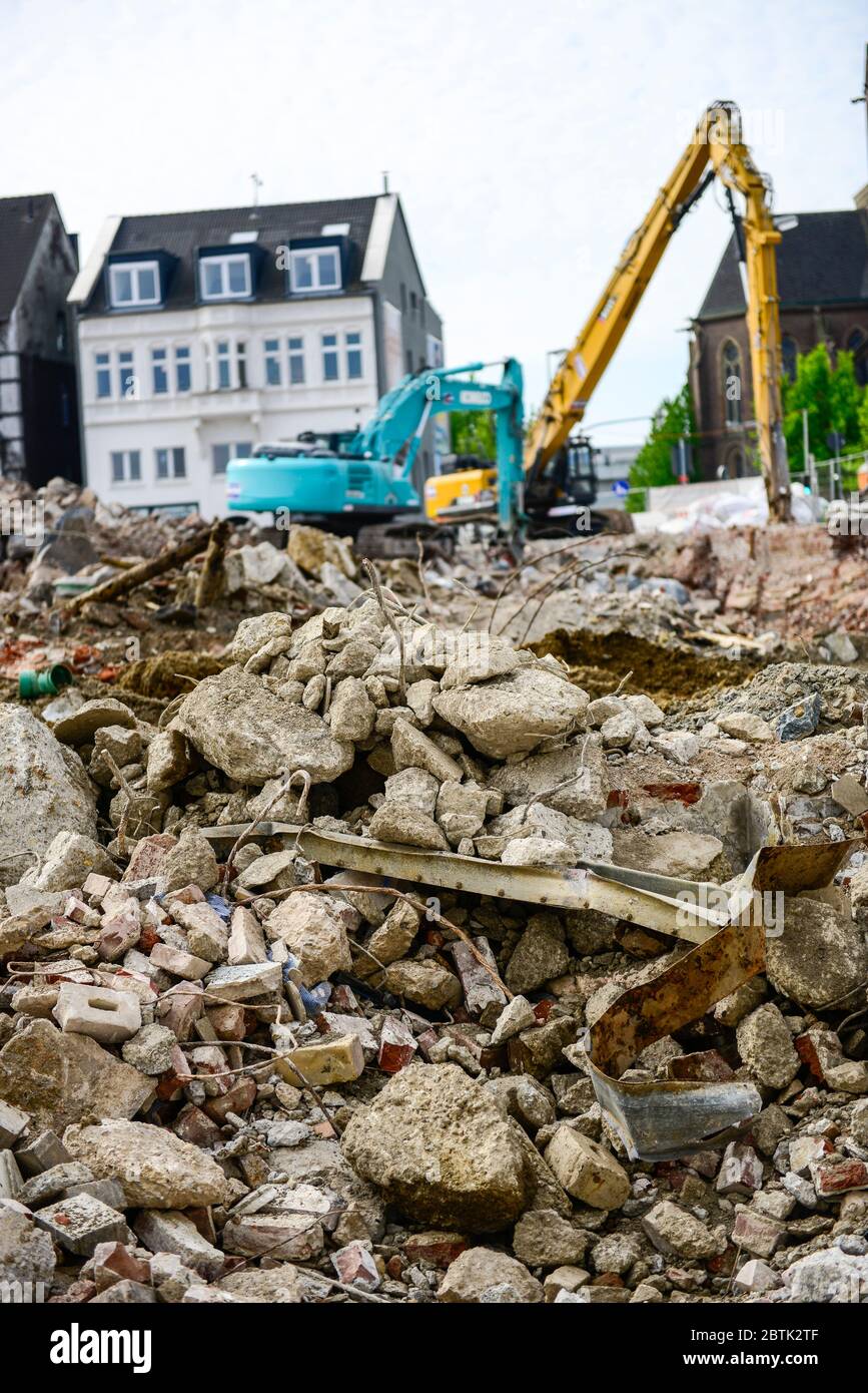 Mechanical grabber, bulldozer demolishes old buildings Stock Photo