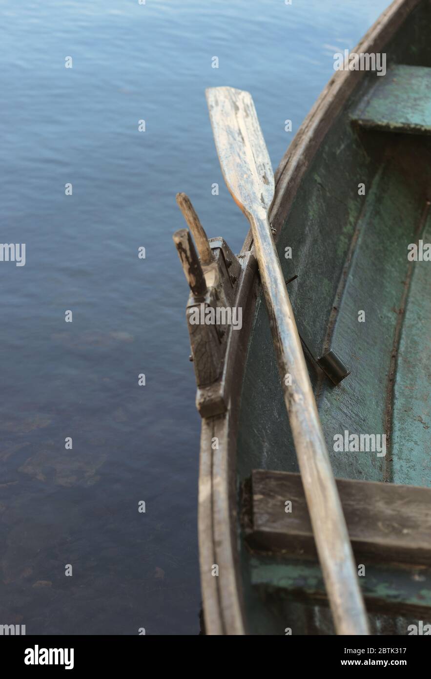 Old wooden row boat with oars. Stock Photo