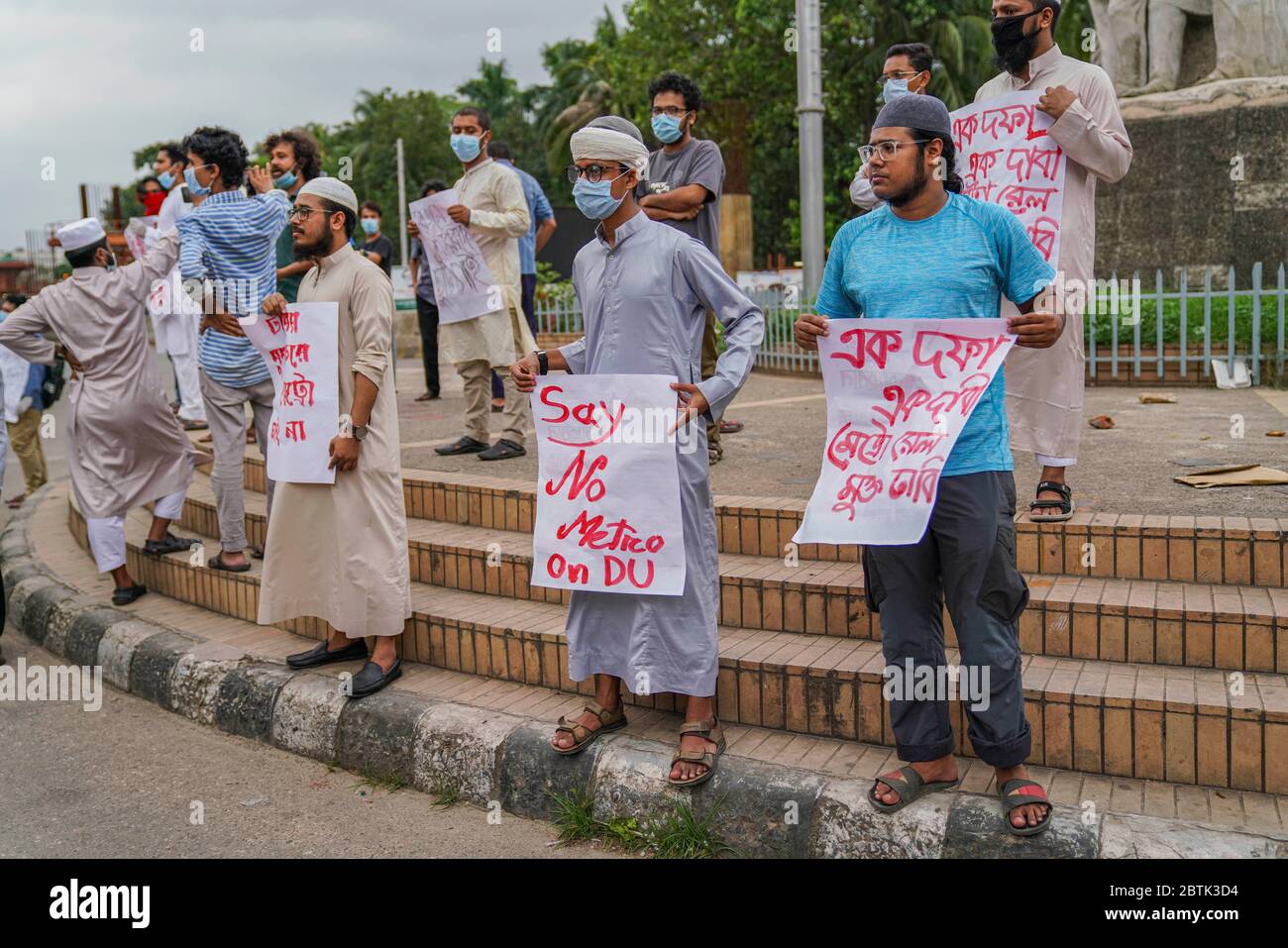 Demonstrators holding placards during the protest.Bangladesh Student's Union members have demanded to stop metro rail construction within the campus area at Raju Memorial Sculpture close to Dhaka University. Stock Photo