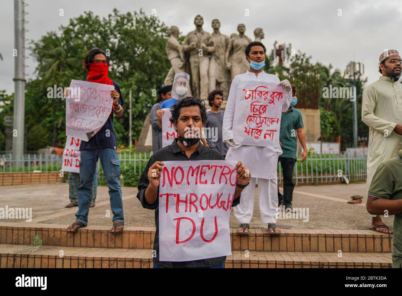 Demonstrators holding placards during the protest.Bangladesh Student's Union members have demanded to stop metro rail construction within the campus area at Raju Memorial Sculpture close to Dhaka University. Stock Photo