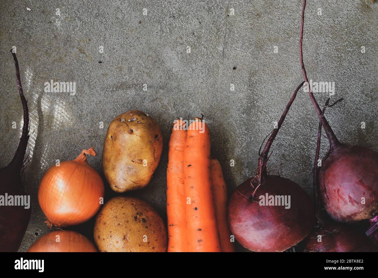 Summer harvest. Beets, potatoes, carrots and onions on a concrete