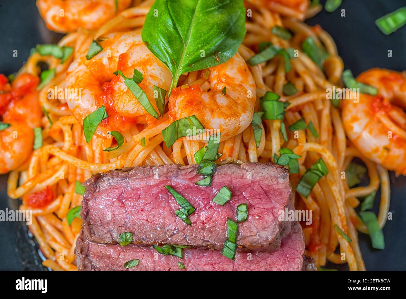 Spaghetti surf and turf basil close-up Stock Photo