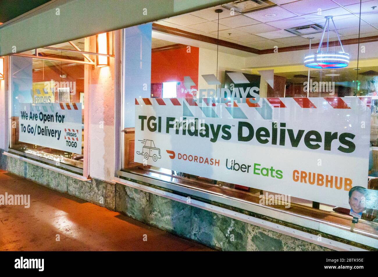 Miami Beach Florida,TGI Fridays, restaurant,takeout take-out delivery delivers to go sign,Doordash Uber Eats Grubhub,Covid-19 coronavirus pandemic cri Stock Photo